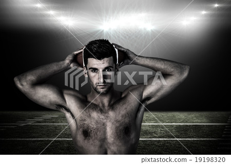Composite image of portrait of a shirtless man holding ball over Composite image of portrait of a shirtless man holding ball over 19198320