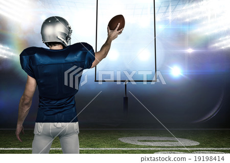 Composite image of rear view of sports player holding ball 19198414