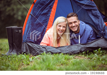 Happy couple lying in their tent 19198688