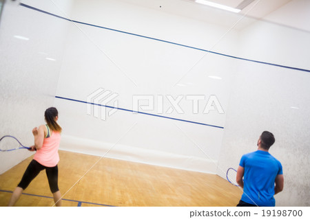 Couple enjoying a game of squash 19198700
