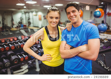 Fit couple smiling at camera 19198889