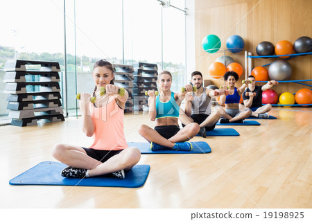 Fitness class exercising in the studio 19198925