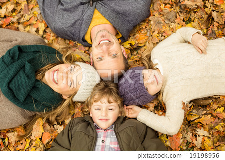 Smiling young family doing a head circles Smiling young family doing a head circles 19198956