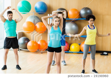 Fitness class exercising in the studio Fitness class exercising in the studio 19198960
