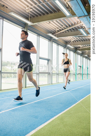 Couple running on the indoor track Couple running on the indoor track 19198970