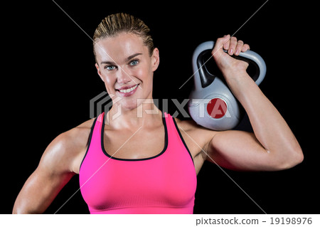 Muscular woman lifting heavy kettlebell Muscular woman lifting heavy kettlebell 19198976