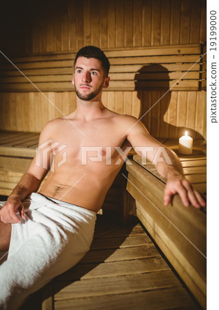 Man sitting inside a sauna 19199000