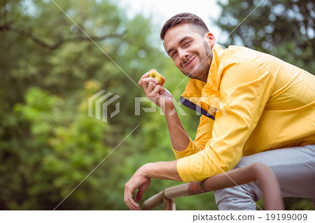 Fit man eating an apple Fit man eating an apple 19199009