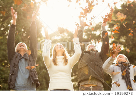 Happy family throwing leaves around 19199278