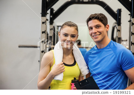 Trainer and woman discussing workout plan Trainer and woman discussing workout plan 19199321