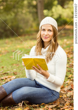 Portrait of a smiling pretty woman reading a book Portrait of a smiling pretty woman reading a book 19199407