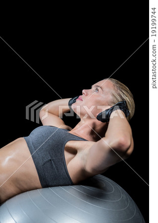 Muscular woman doing sit ups 19199744