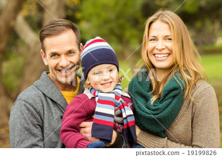 Smiling young couple with little boy posing 19199826