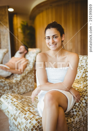 Smiling woman sitting on a chair 19199869