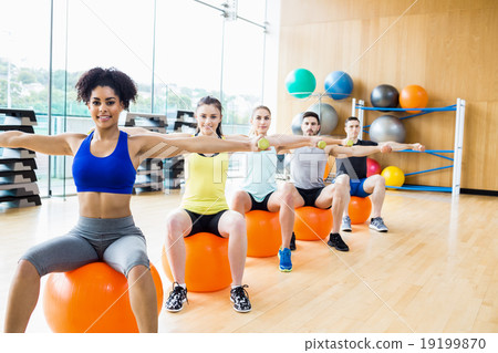 Fitness class exercising in the studio 19199870