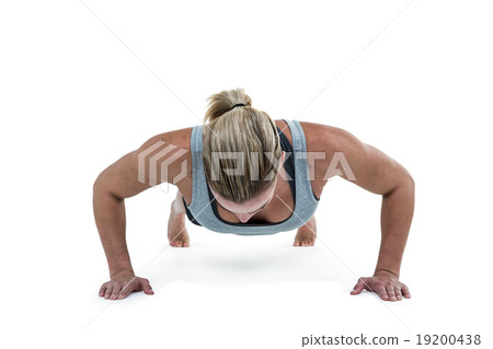 Muscular woman doing push-ups 19200438