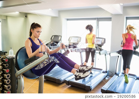 Fit people working out using machines 19200586