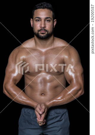 Portrait of a bodybuilder man flexing muscles Portrait of a bodybuilder man flexing muscles 19200587