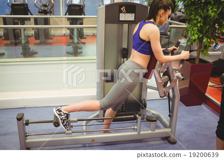 Fit woman using exercise equipment 19200639