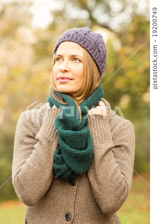 Smiling pretty woman holding her scarf 19200749