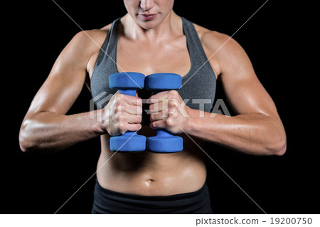 Muscular woman lifting heavy dumbbells 19200750