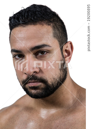 Muscular man frowning at camera Muscular man frowning at camera 19200895