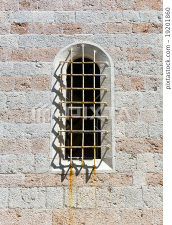 Arched old window in a stone wall 19201860