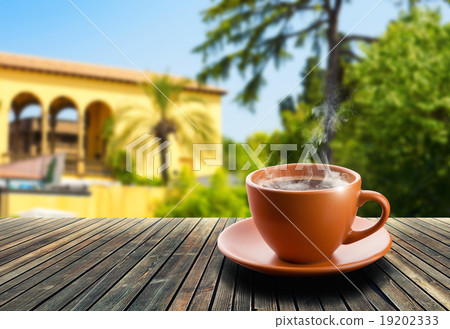 Cup of coffee on nature background Cup of coffee on nature background 19202333
