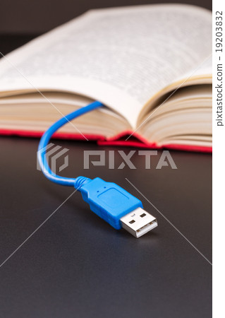 Usb cable sticks out from red book Usb cable sticks out from red book 19203832