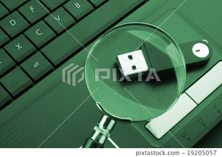 Magnifying glass focused on the flash drive 19205057