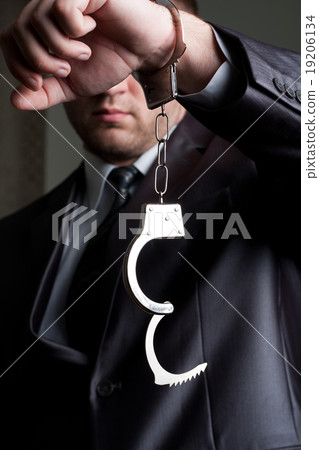 Businessman with unlocked handcuffs Businessman with unlocked handcuffs 19206134