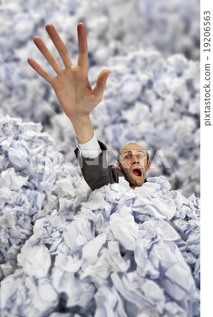 Businessman sinking in big heap of crumpled papers 19206563
