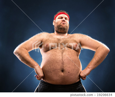 Fat man imitating muscular build 19206634