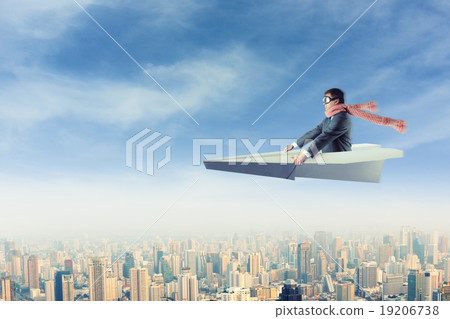 Man on paper airplane above the city 19206738