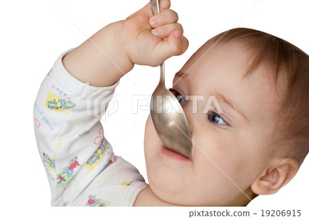 Baby girl holding spoon in mouth 19206915
