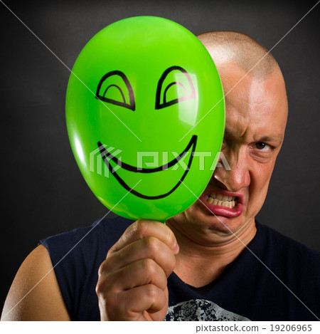 Angry man hiding behind happy balloon Angry man hiding behind happy balloon 19206965