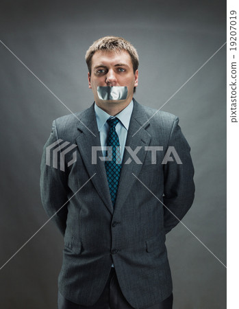 Man with mouth covered by masking tape Man with mouth covered by masking tape 19207019
