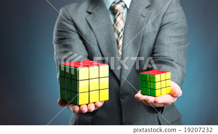 Businessman holding rubik cube in his hands Businessman holding rubik cube in his hands 19207232