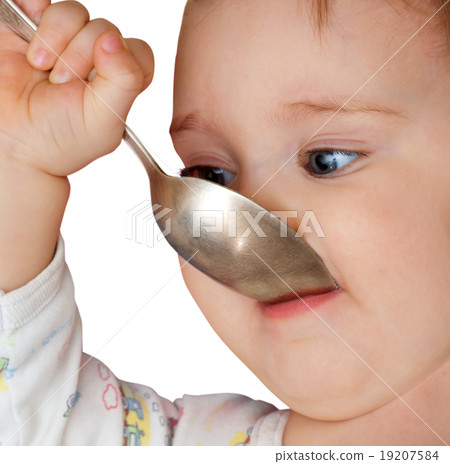 Baby girl holding spoon in mouth 19207584
