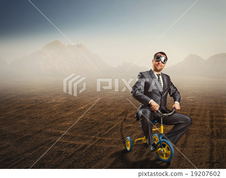 Odd businessman riding a small bicycle Odd businessman riding a small bicycle 19207602