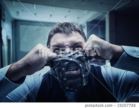 Angry man in muzzle 19207788