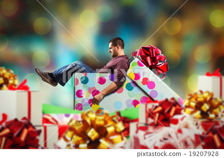 Adult man sits in present box Adult man sits in present box 19207928