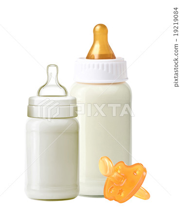 bottles of milk and soother isolated on white bottles of milk and soother isolated on white 19219084
