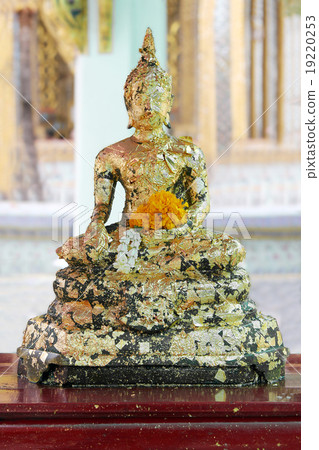 The old statue Buddha image covered with gold leaf The old statue Buddha image covered with gold leaf 19220253