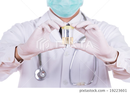 doctor's hand holding a bottle of urine 19223601