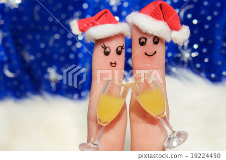 Finger art of a Happy couple in the new year hats. 19224450