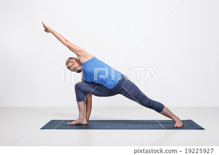 Woman doing Ashtanga Vinyasa Yoga asana 19225927