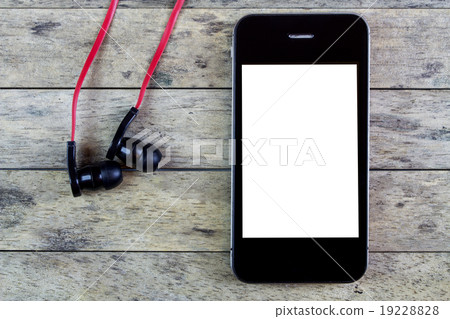 earphones and smart phone on a wooden table 19228828