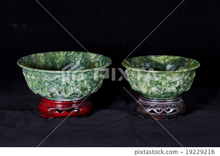 Two Jade bowls with wooden base isolated on dark Two Jade bowls with wooden base isolated on dark 19229216