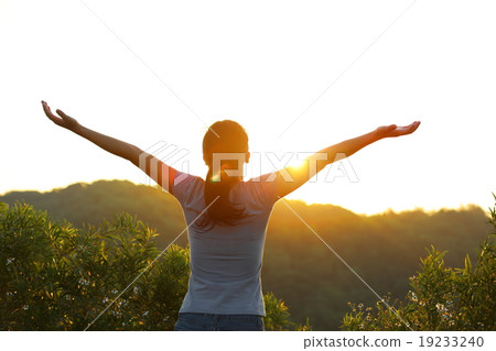 cheering woman open arms at sunrise mountain peak cheering woman open arms at sunrise mountain peak 19233240